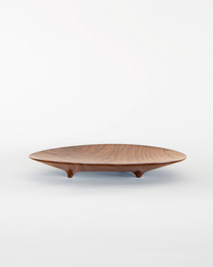 footed black walnut plate in an asymmetrical shape. Handmade by Korean artist Heum Namkung.