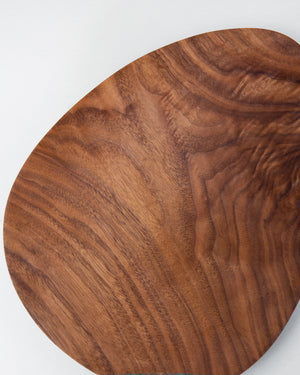 footed black walnut plate in an asymmetrical shape. Handmade by Korean artist Heum Namkung.