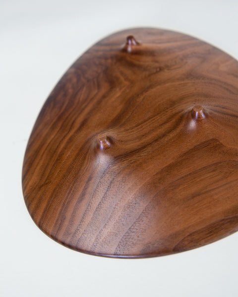 Load image into Gallery viewer, footed black walnut plate in an asymmetrical shape. Handmade by Korean artist Heum Namkung.
